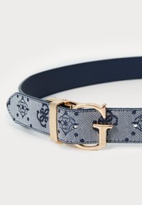 Navy blue belt made of textured fabric, featuring a gold-tone buckle and floral patterns, with multiple adjustment holes for fitting.