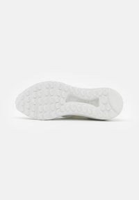 White sneaker sole with rounded rubber grips, rectangle cutout, and smooth edges. Pebbled texture for traction and durability.