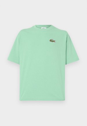 Maglietta verde menta a maniche corte con collo rotondo e piccolo logo ricamato di coccodrillo verde sul petto sinistro.