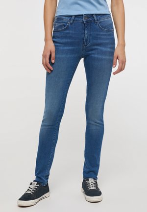 Jean skinny bleu en denim, avec une taille mi-haute, cinq poches et une décoloration subtile le long des jambes. Style décontracté avec une coupe ajustée.