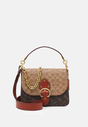 Brown and tan shoulder bag with patterned flap, gold chain accent, and large gold buckle on front against a plain light background.