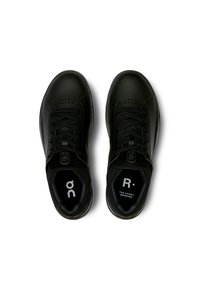 Mustat nahkaiset lenkkarit, joissa on sileä pinta, rei'itettyjä yksityiskohtia varpaiden läheisyydessä ja mustat nauhat. Sisäpuolella on logot.