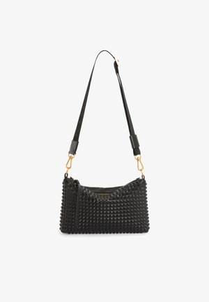 Black leather handbag with a textured, pyramid-patterned surface. Features a gold hardware clip and adjustable strap for versatile carrying.