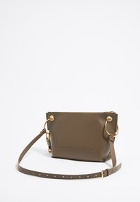 Olive green leather handbag with gold hardware, zip closure, flat front pocket, and adjustable strap. Textured finish, compact design.
