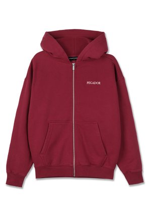 Maroon zip-up hoodie made from soft fabric, featuring a spacious hood, front pockets, and "PEGADOR" logo in white on the left chest.