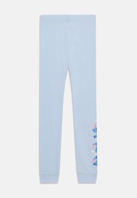 Leggings bleu clair en tissu doux avec un design ajusté, présentant un motif graphique de personnages de dessins animés sur le côté gauche.