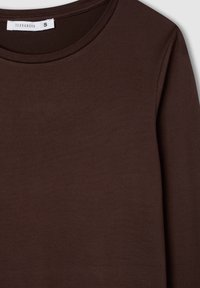 Brązowa bluzka z długim rękawem, wykonana z miękkiego, elastycznego materiału, z okrągłym dekoltem i minimalnymi detalami szwów, z metką "Terranova S".