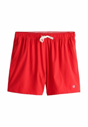 Red swim shorts made from lightweight material, featuring an elastic waistband with a drawstring, side pockets, and a small logo detail.