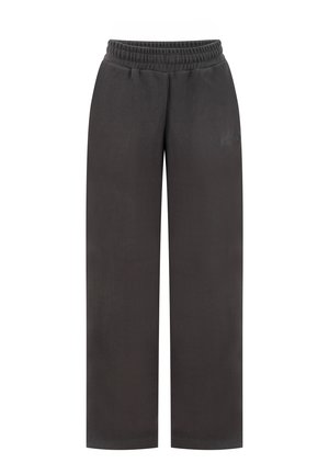 Schwarz geschnittene, locker sitzende Jogginghose mit elastischem Bund und dezentem, gesticktem Logo am linken Oberschenkel, auf weißem Hintergrund gezeigt.