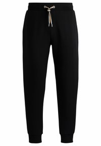 Pantalons de jogging noirs en tissu doux, dotés d'une taille élastique avec cordon de serrage, de jambes fuselées et de poignet côtelé aux chevilles.
