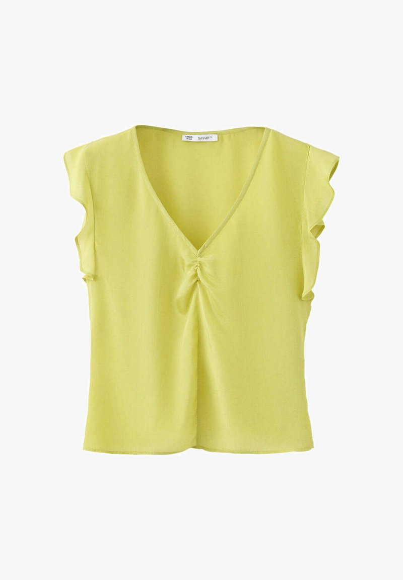 Blouse sans manches vert clair avec col en V et petit détail froncé au centre devant.