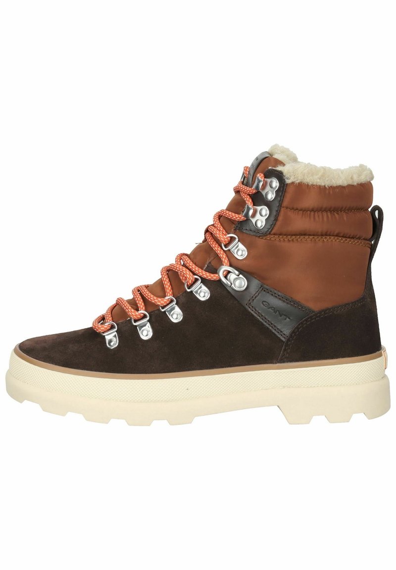 Brown and tan hiking boot with orange laces, metal eyelets, thick cream sole, and fleece lining around the ankle collar.