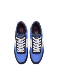Blue mesh sneakers with navy blue accents, white stripes, and cream laces. Logo visible on tongue; rubber sole. Classic athletic design.