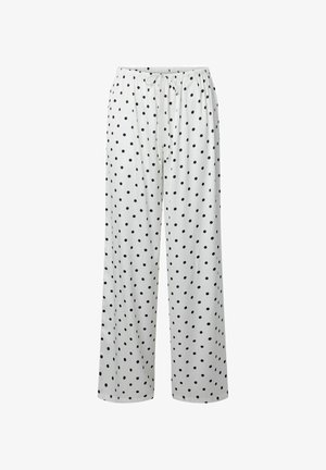 Pantalon blanc ample à pois noirs avec une taille élastique dotée d'un cordon ajustable.
