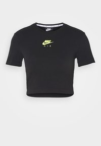 Černé zkrácené tričko z bavlny s krátkými rukávy. Uprostřed je logo Nike Air v neonově žluté barvě. Měkká textura, klasický design s kulatým výstřihem.
