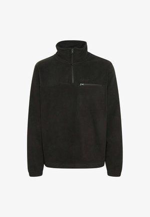 Čierny flísový pulóver s vysokým golierom. Má zipsovú náprsné vrecko a rebrované manžety. Mäkko a voľne strih.