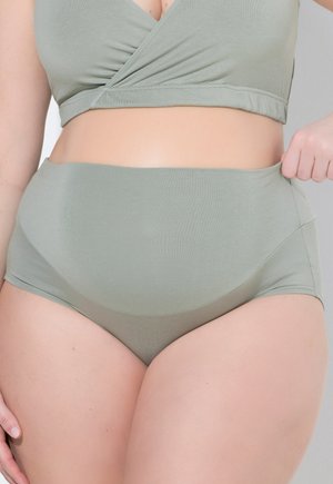 Grünes geripptes Stoff-Bralette und hochgeschnittenes Unterwäsche-Set. Das Bralette hat ein Wickeldesign, während die Unterwäsche eine glatte Textur aufweist.