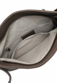Brown textured leather bag interior with gray lining, featuring one zipped pocket and one open compartment for organization.