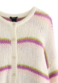 Pletený krémový kardigan s horizontálními pruhy v purpurové, růžové a zelené barvě. Má kulatý výstřih a zapínání na pět knoflíků.