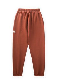 Rostfarbene Jogginghosen aus weichem Stoff, mit einem elastischen Bund und schmal zulaufenden Bündchen, versehen mit einem kleinen Logotag an der Seite.