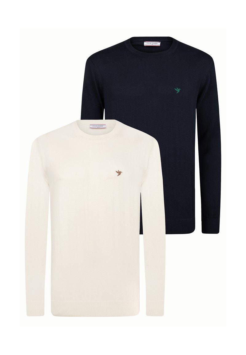 Twee crew neck sweaters tentoongesteld: de ene in crèmekleur met een klein bruin vogel logo, de andere in marineblauw met een groen logo. Beide hebben geribbelde manchetten.