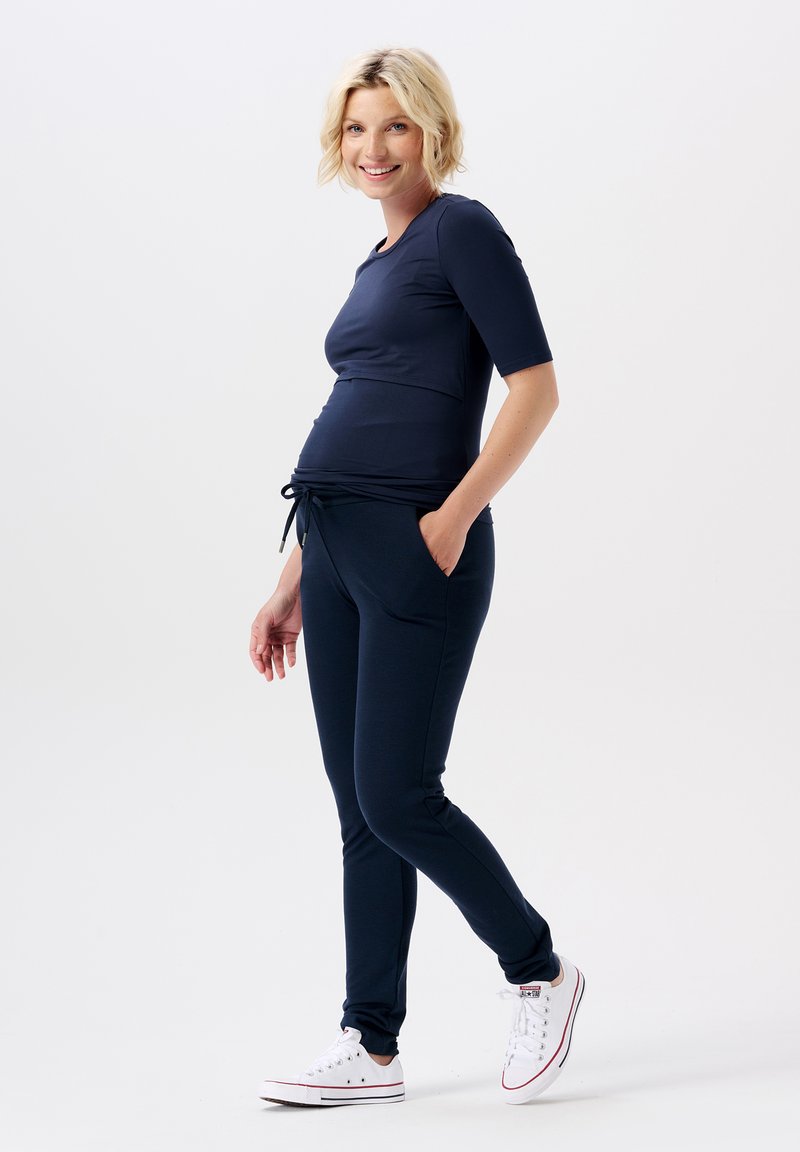 Navy maternity top with short sleeves and a rounded neckline, paired with matching joggers featuring a drawstring waist and side pockets.