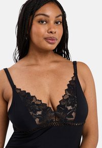 Black lingerie with a lace v-neck design, featuring floral patterns and adjustable straps. The fabric is smooth with a fitted silhouette.