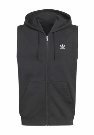 Čierna bezrukávová mikina s kapucňou na zips vpredu, dvoma bočnými vreckami a sťahovacou šnúrkou na kapucni. Na ľavej strane hrude biely logo Adidas.