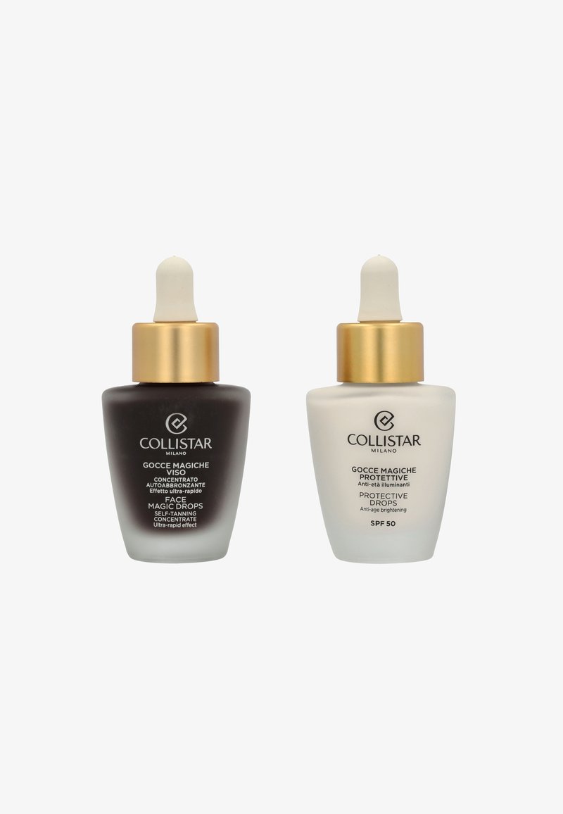 Two glass dropper bottles side by side. Left: dark brown with a gold cap, labeled "Face Magic Drops." Right: white with a gold cap, labeled "Protective Drops SPF 50."