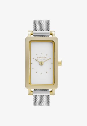 Reloj de pulsera rectangular Skagen en tono dorado con esfera blanca, indicadores y manecillas doradas, y correa de malla plateada mostrando la hora 10:10.