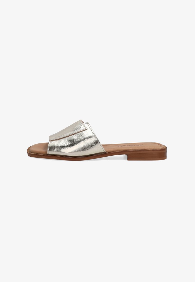 Flat slide sandal featuring a shiny metallic silver upper, a wide band over the foot, and a smooth brown sole. Simple and minimalistic design.