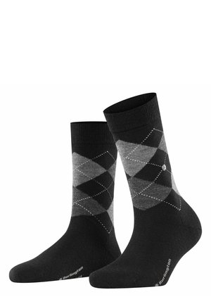 Chaussettes en motif argyle noir et gris avec des bouts côtelés, texture douce et talon et orteil renforcés. Logo visible près de la cheville.