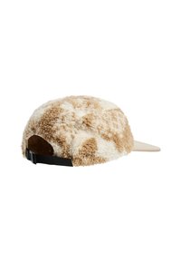 Tan and white fuzzy cap with a textured surface, featuring a curved brim and an adjustable black strap at the back.