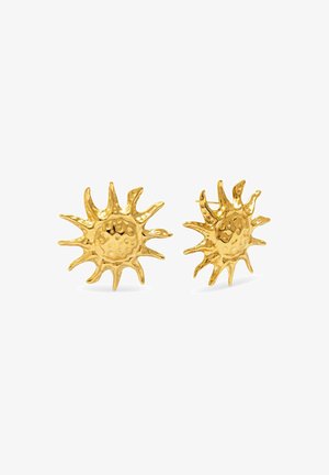 Boucles d'oreilles en or en forme de soleil avec une surface texturée et des rayons allongés. Elles possèdent un dôme central avec de petites indentations pour les détails.