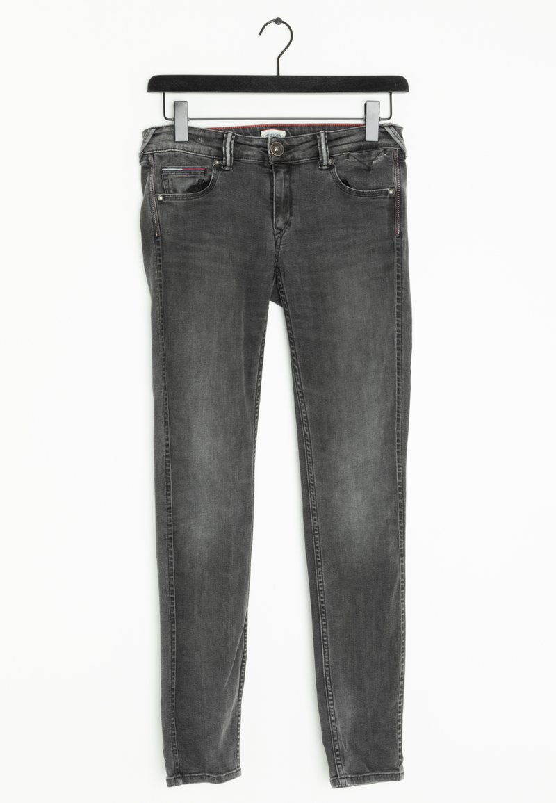 Jeans slim-fit negros con un lavado desgastado, diseño clásico de cinco bolsillos y cierre de botón metálico. Hechos de denim con detalles de costura sutiles.