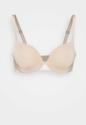 Beige padded bra with smooth fabric, underwire support, adjustable straps, and a triangular center. Simple design with no patterns.