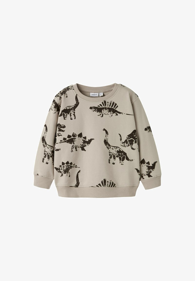 Helles beiges Sweatshirt mit schwarzen Dinosaurier-Drucken, darunter Stegosaurus und Brontosaurus, mit geripptem Kragen und Bündchen.