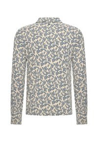 Koszula z długim rękawem z kremowym tłem i niebieskim wzorem liści, zapinana na kołnierzyk z guzikami na mankietach. Miękki materiał o gładkiej fakturze.