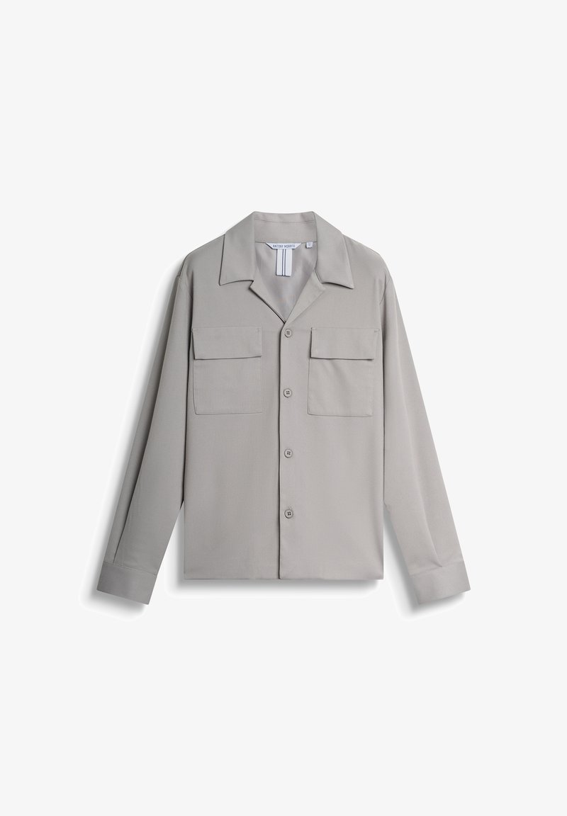 Light gray button-up shirt with a pointed collar, two chest pockets, and long sleeves. Smooth fabric texture, minimalistic design.