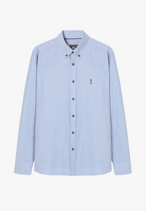 Hele sinine pikkade varrukatega nööbiga särk, millel on krae, tumedast pruunist nööbid ja väike tikand rinnapiiril.