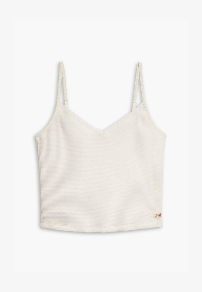 Top court blanc côtelé avec de fines bretelles réglables, design en V, et une petite étiquette sur le côté inférieur. Texture de tissu lisse.