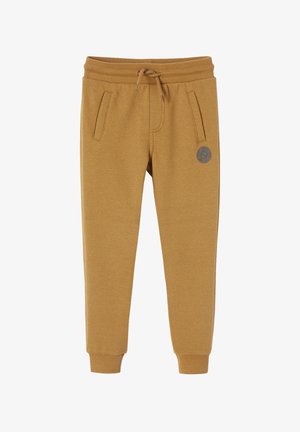 Hellbraune Jogginghosen mit gerippten Bündchen, Kordelzugbund, zwei Fronttaschen und kleinem rundem Logo-Patch am linken Oberschenkel.