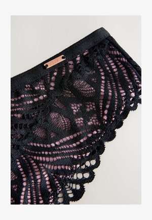 Melna mežģīņu apakšveļa ar rozā akcentiem, sarežģītiem rakstiem, viļņainiem malām un mazu metalizētu birku ar uzrakstu "LIPSY".