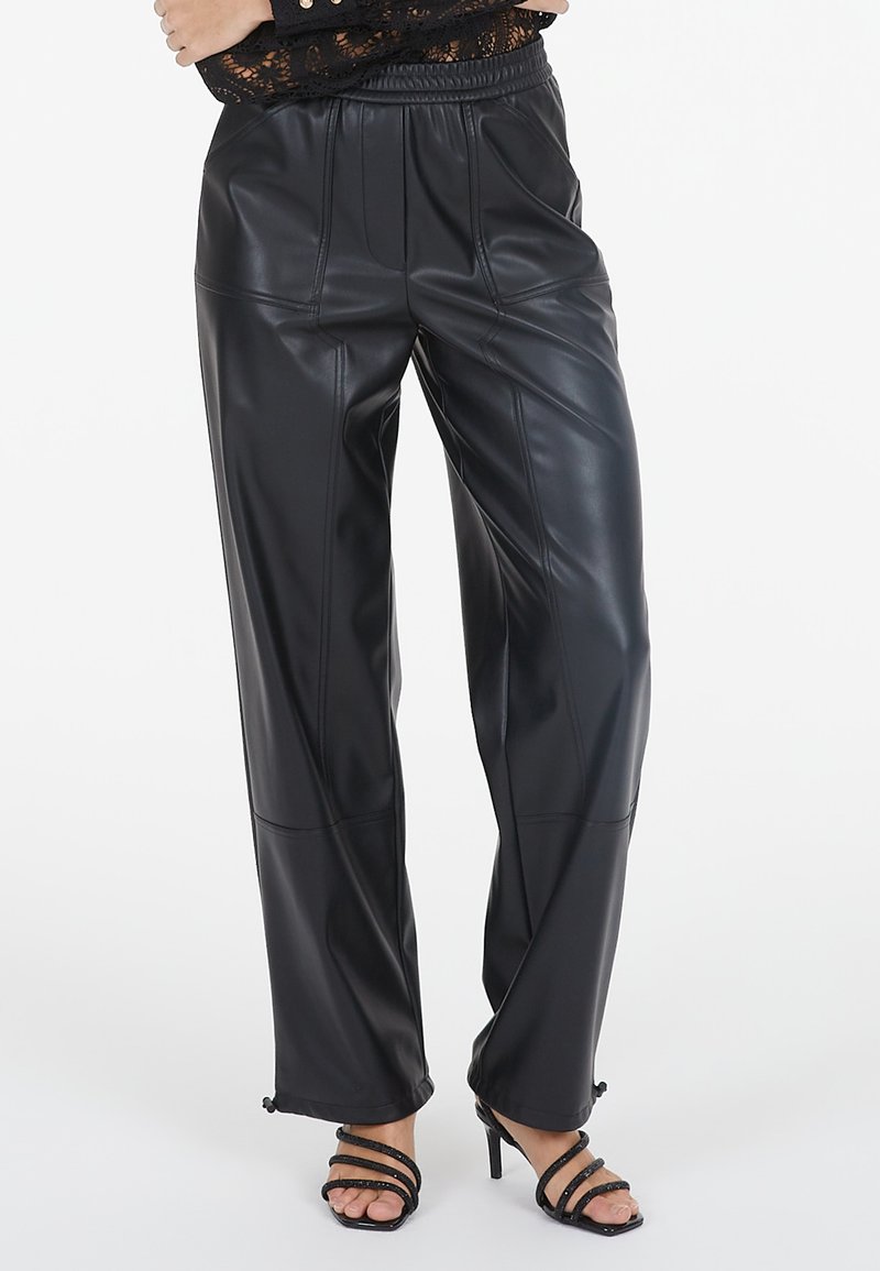Schwarze Kunstlederhosen mit lockerer Passform, vertikalen Nähten, elastischem Bund und verstellbaren Bündchen. Glatte Textur und elegantes Design.
