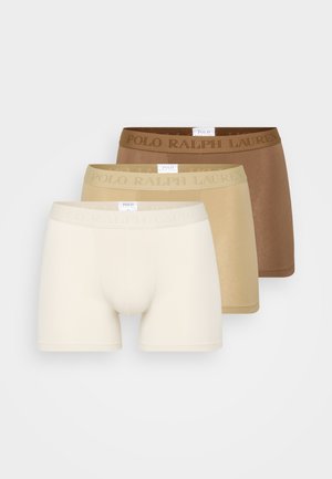 Trois paires de boxers en tons beiges, comprenant du beige clair, du tan moyen et du marron foncé, avec des ceintures texturées affichant "POLO RALPH LAUREN."