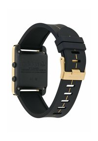 Črn in zlat Adidas relo z pravokotnim facem in gumijastim trakcem, ki prikazuje gumbe na strani in gravirane podrobnosti na hrbtni strani.