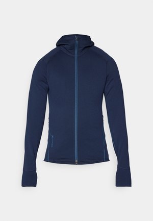 Navy zip-up hoodie with a fitted design, featuring long sleeves, a high collar, and blue accent stitching along the seams.