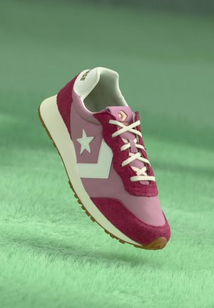 Pink sneaker with white star and logo, suede and synthetic material, textured accents in darker pink, white laces, rubber sole.