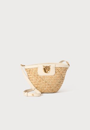 Woven straw crossbody bag with a cream-colored leather trim, round gold hardware closure, and adjustable strap. Textured surface, neutral tones.