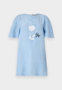 Helles blaues kurzärmeliges Kleid mit gewelltem Saum, das weiße Blumendekorationen und schwarzen Text mit der Aufschrift "Nicht nur ein hübsches Gesicht" zeigt.